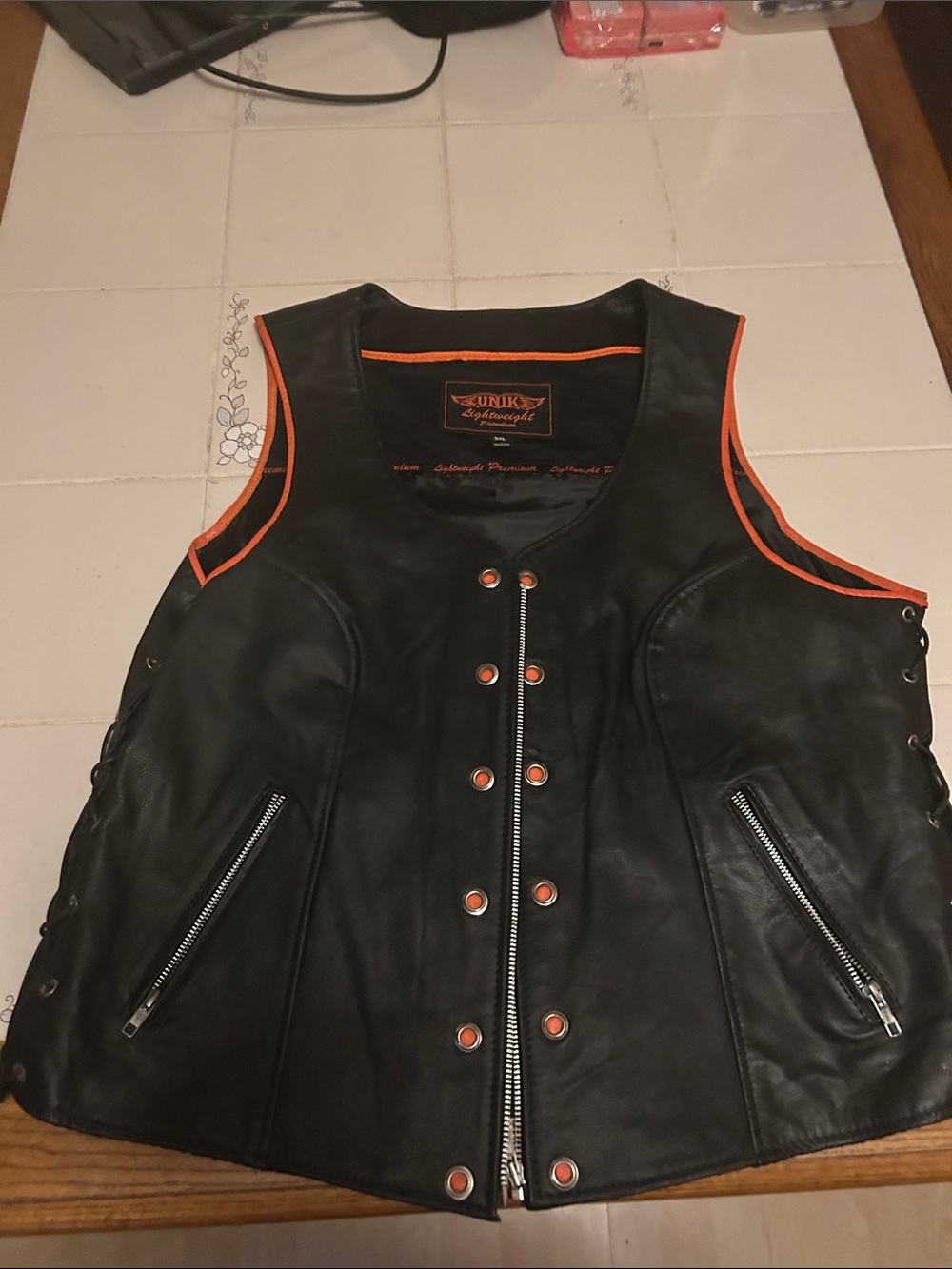 Unik Black Vest with Orange Accents and Logo Patch